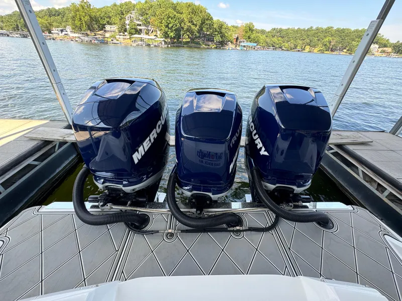 Slide: The Image of 2019 Nor-Tech 390 Sport Center Console with triple Mercury outboard engines on a lake. - 19