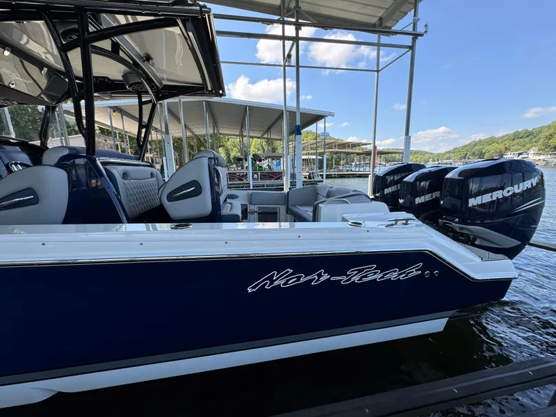 Slide: The Image of 2019 Nor-Tech 390 Sport Center Console boat docked with Mercury engines. - 23