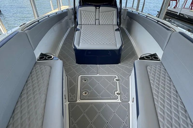 Slide: The Image of 2019 Nor-Tech 390 Sport Center Console interior with diamond-stitched seating and sleek design. - 29