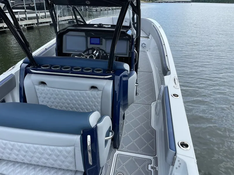 Slide: The Image of 2019 Nor-Tech 390 Sport Center Console boat interior with luxurious seating and modern dashboard. - 3