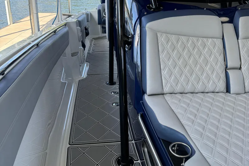 Slide: The Image of 2019 Nor-Tech 390 Sport Center Console interior with diamond-stitched seating and sleek design. - 30
