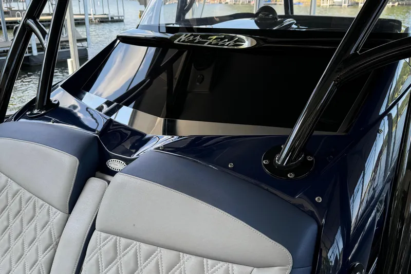 Slide: The Image of 2019 Nor-Tech 390 Sport Center Console boat interior with sleek design and comfortable seating. - 34