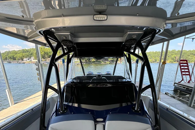 Slide: The Image of 2019 Nor-Tech 390 Sport Center Console boat docked by a scenic lake. - 35