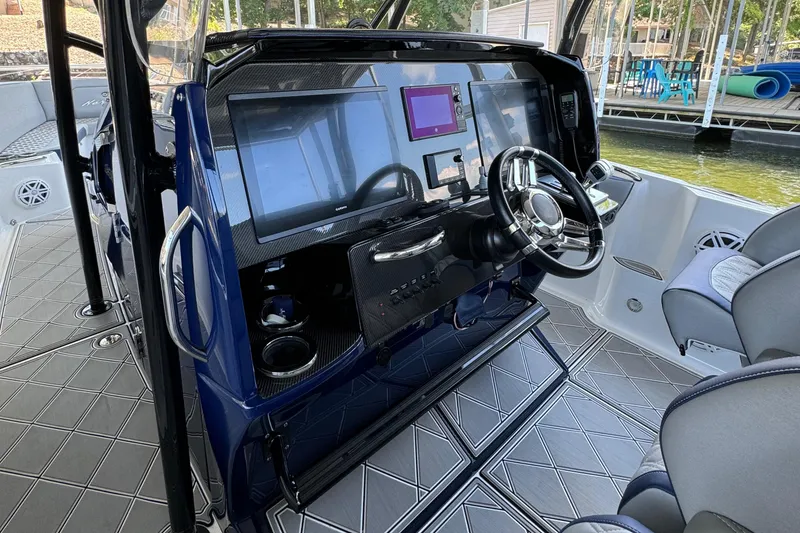 Slide: The Image of 2019 Nor-Tech 390 Sport Center Console dashboard with modern controls and steering wheel. - 36