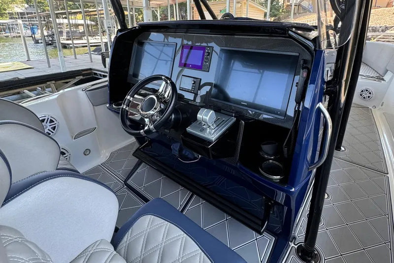 Slide: The Image of 2019 Nor-Tech 390 Sport Center Console helm with advanced navigation displays and controls. - 38