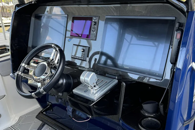 Slide: The Image of 2019 Nor-Tech 390 Sport Center Console dashboard with steering wheel and navigation screens. - 40