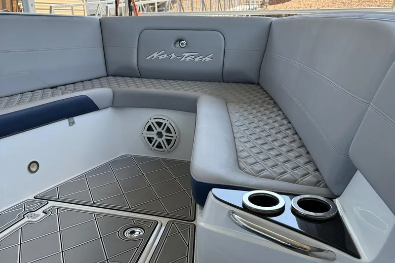 Slide: The Image of 2019 Nor-Tech 390 Sport Center Console interior with quilted seating and cup holders. - 44