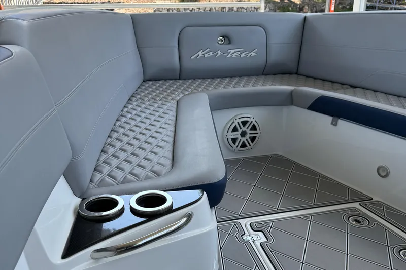 Slide: The Image of 2019 Nor-Tech 390 Sport Center Console interior with gray seating and cup holders. - 45