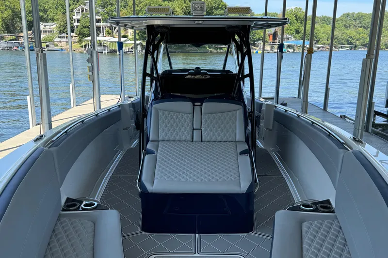 Slide: The Image of 2019 Nor-Tech 390 Sport Center Console boat interior with luxurious seating and lake view. - 48