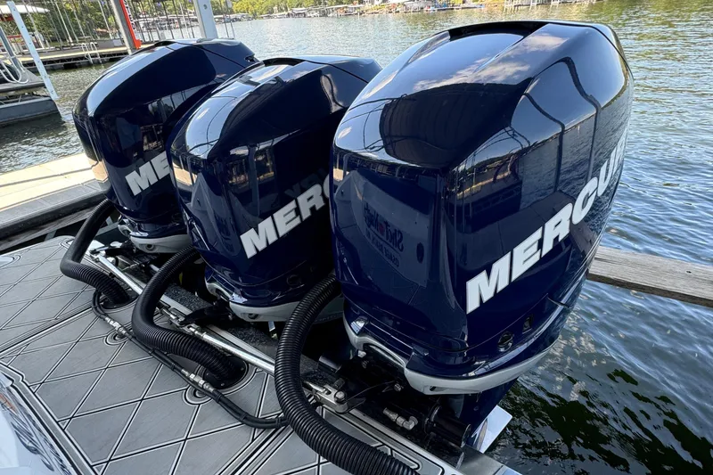 Slide: The Image of Triple Mercury outboard engines on a 2019 Nor-Tech 390 Sport Center Console boat. - 49