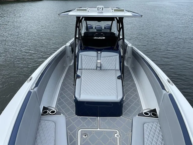 Slide: The Image of 2019 Nor-Tech 390 Sport Center Console boat with luxurious seating on calm water. - 5