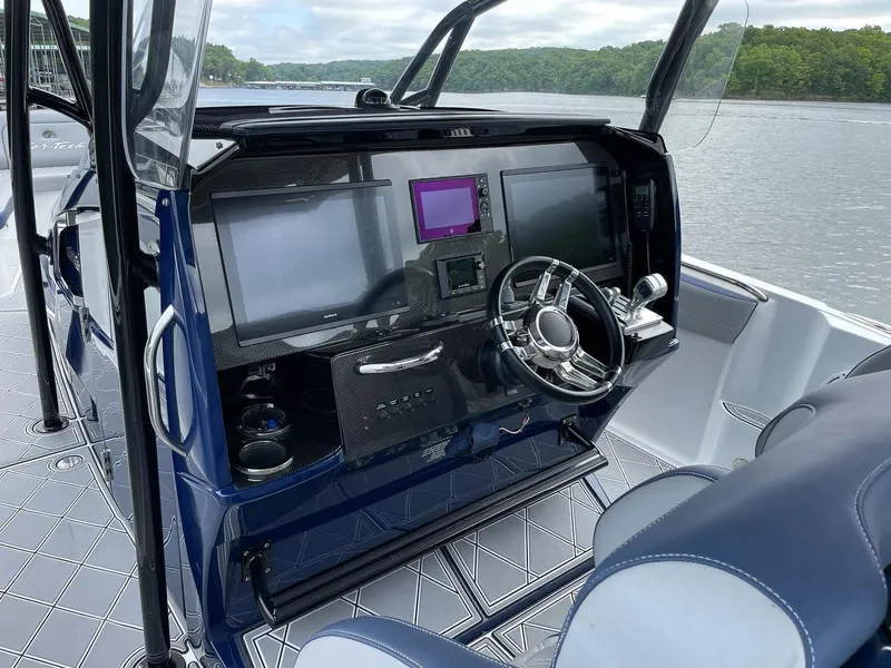 Slide: The Image of 2019 Nor-Tech 390 Sport Center Console dashboard with modern navigation screens and steering wheel. - 6