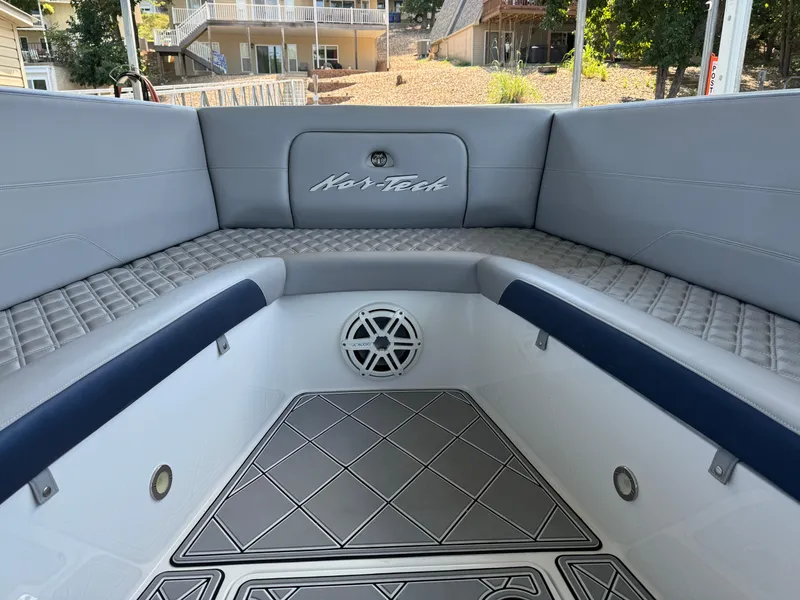 Slide: The Image of 2019 Nor-Tech 390 Sport Center Console interior with cushioned seating and speaker. - 8