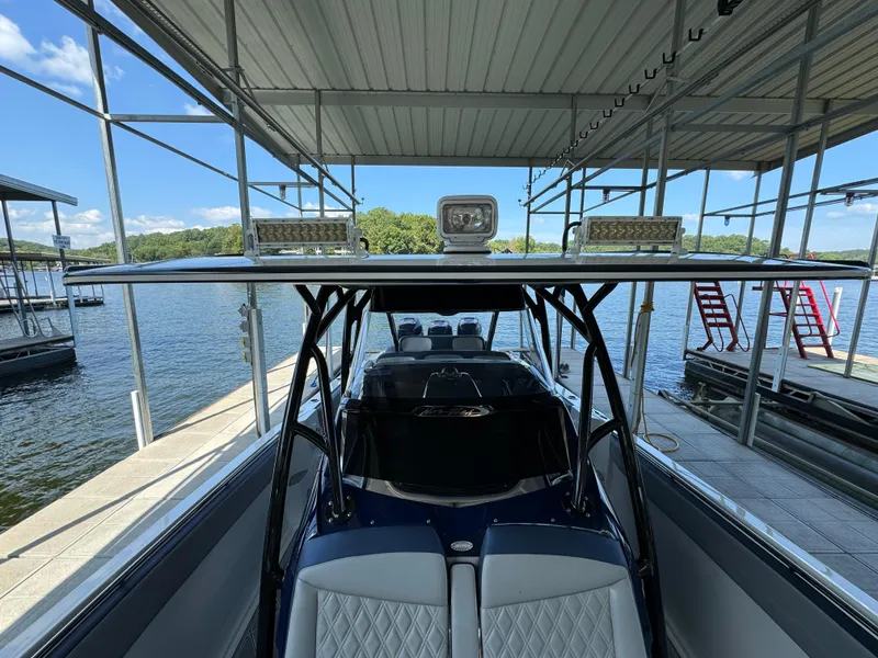 Slide: The Image of 2019 Nor-Tech 390 Sport Center Console docked under a covered marina. - 9
