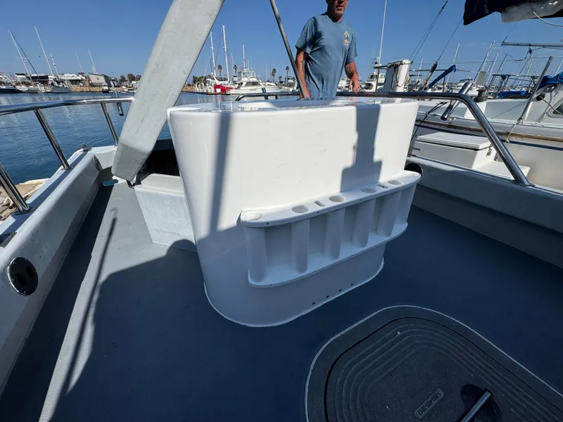 Slide: The Image of Boat deck with fishing rod holders, Anderson 26 model, 1992, docked at marina. - 11