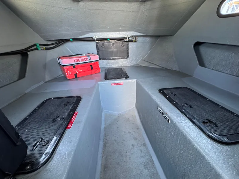 Slide: The Image of Interior of a 1992 Anderson 26 boat with life jackets and storage compartments. - 15