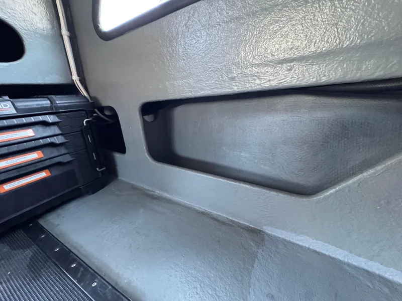 Slide: The Image of Interior of a 1992 Anderson 26, featuring storage compartments and toolboxes. - 18