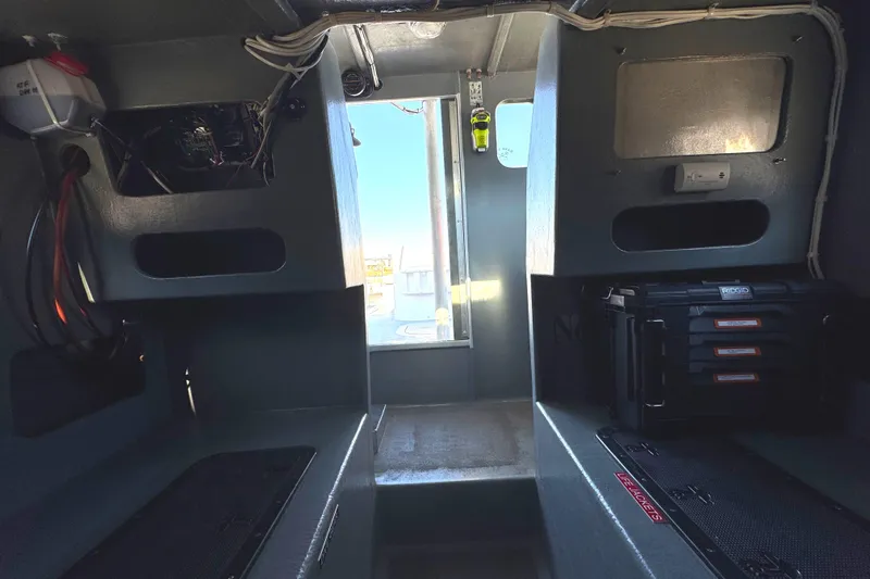 Slide: The Image of Interior of a 1992 Anderson 26 boat, featuring storage compartments and equipment. - 19