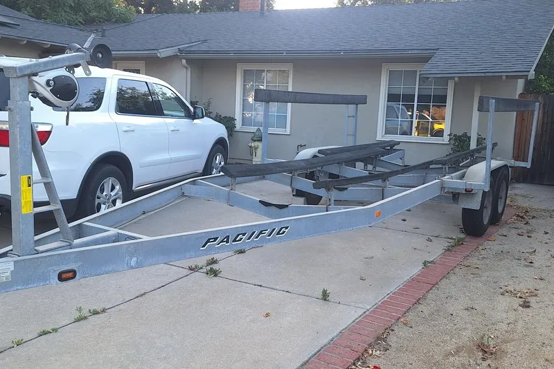 Slide: The Image of Boat trailer parked in driveway beside white SUV, Anderson 26 model, 1992. - 20