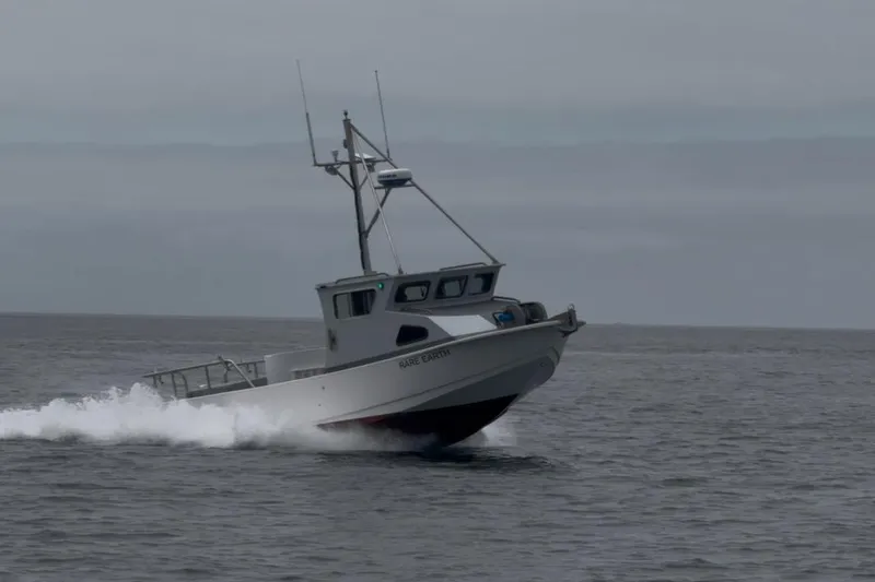 Slide: The Image of Anderson 26 boat from 1992 speeding on open water under cloudy skies. - 21