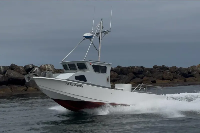 Slide: The Image of 1992 Anderson 26 boat "Rare Earth" cruising near rocky shoreline. - 22