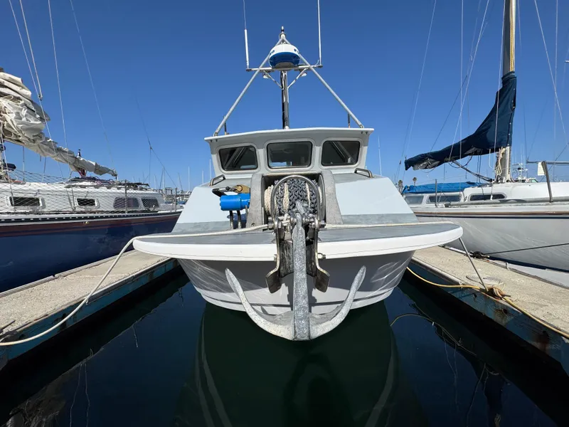 Slide: The Image of Front view of a 1992 Anderson 26 boat docked at a marina. - 3