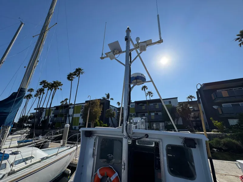 Slide: The Image of Boat docked at marina with palm trees and buildings in background, sunny day. Anderson 26, 1992. - 4
