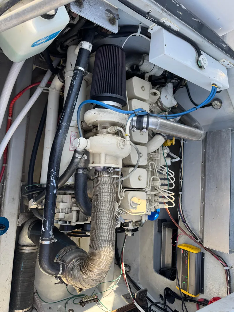 Slide: The Image of Engine compartment of a 1992 Anderson 26 boat, showcasing detailed mechanical components. - 9