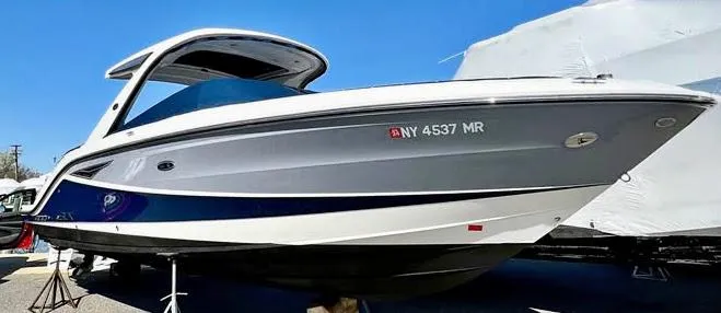 Slide: The Image of 2016 Sea Ray 310 SLX boat with sleek design, docked under clear blue sky. - 2