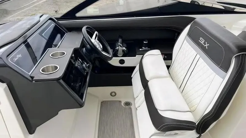 Slide: The Image of 2016 Sea Ray 310 SLX helm with steering wheel and luxurious seating. - 7