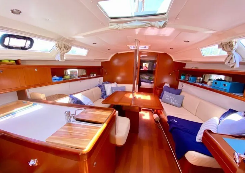 Slide: The Image of Interior of 2012 Beneteau Oceanis 37 sailboat with cozy seating and wooden finishes. - 14