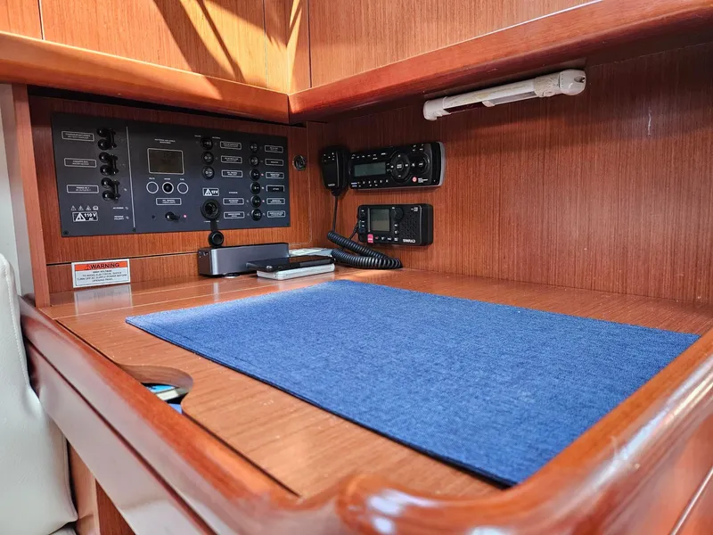 Slide: The Image of Navigation station on 2012 Beneteau Oceanis 37 yacht with control panel and radio equipment. - 22