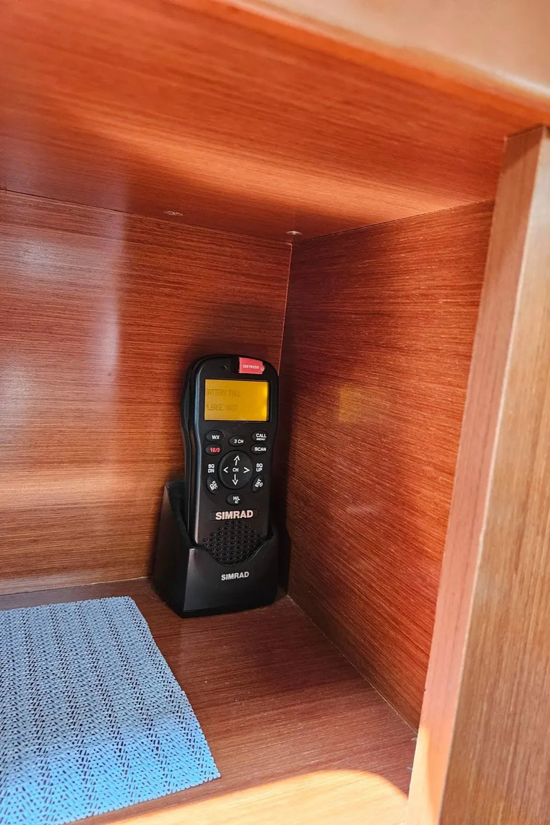 Slide: The Image of Simrad marine radio in wooden cabinet of 2012 Beneteau Oceanis 37 sailboat. - 23