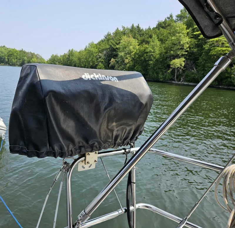 Slide: The Image of Beneteau Oceanis 37 sailboat with Dickinson grill cover, 2012 model, on a serene lake. - 7
