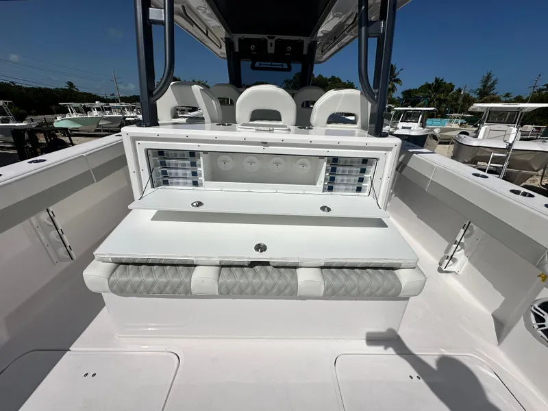 Slide: The Image of 2026 Twin Vee 400 GFX2 CC boat interior with seating and storage compartments. - 10
