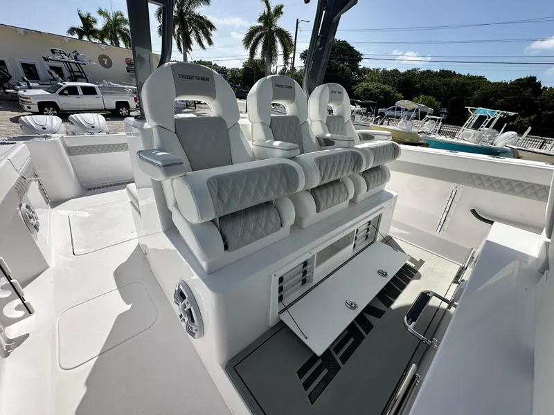 Slide: The Image of Luxury seating on 2026 Twin Vee 400 GFX2 CC boat, featuring modern design and storage. - 11