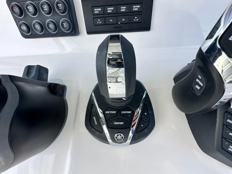 Slide: The Image of Control panel of 2026 Twin Vee 400 GFX2 CC boat with joystick and buttons. - 14