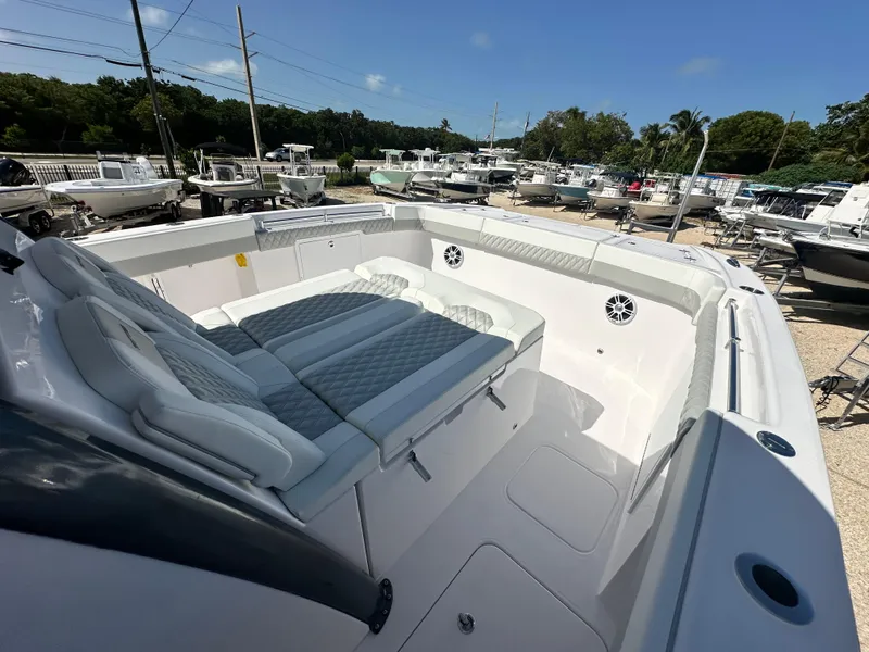 Slide: The Image of 2026 Twin Vee 400 GFX2 CC boat interior with cushioned seating and sleek design. - 17