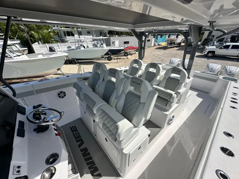 Slide: The Image of 2026 Twin Vee 400 GFX2 CC boat interior with luxurious seating and modern helm controls. - 22