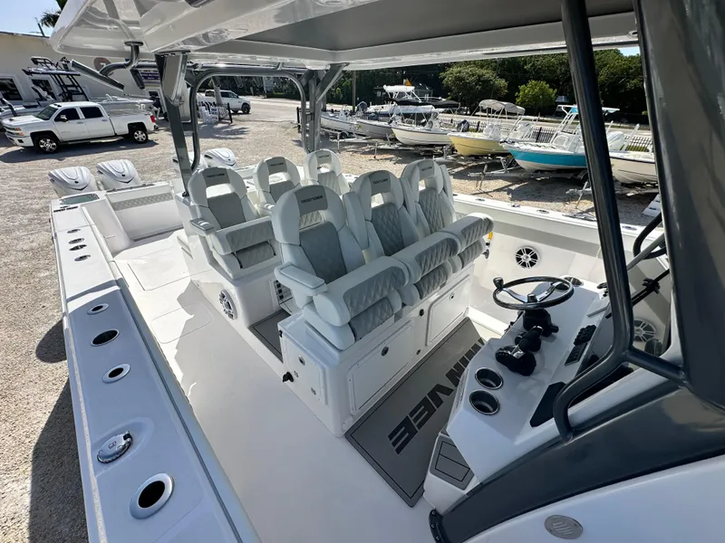 Slide: The Image of 2026 Twin Vee 400 GFX2 CC boat interior with luxurious seating and modern controls. - 25