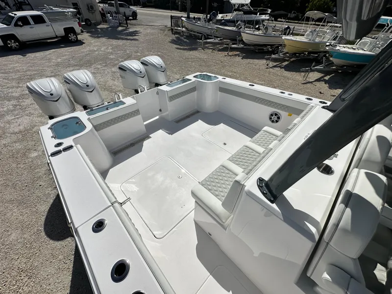 Slide: The Image of 2026 Twin Vee 400 GFX2 CC boat interior with four outboard motors, spacious seating, and storage. - 26