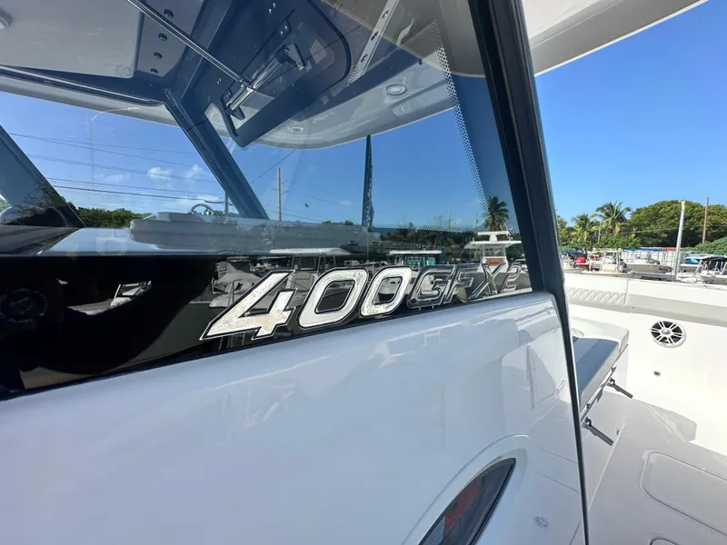 Slide: The Image of 2026 Twin Vee 400 GFX2 CC boat, sleek design, sunny marina background. - 30