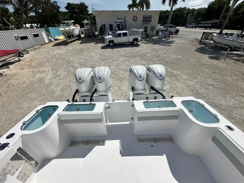 Slide: The Image of 2026 Twin Vee 400 GFX2 CC boat with four powerful outboard engines in a dealership lot. - 6