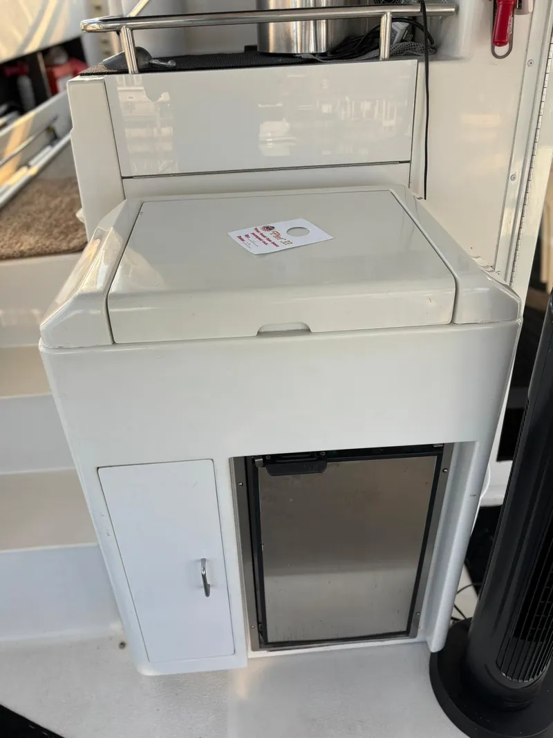 Slide: The Image of 2000 Carver 406 Aft Cabin Motor Yacht interior with storage compartment and mini fridge. - 10