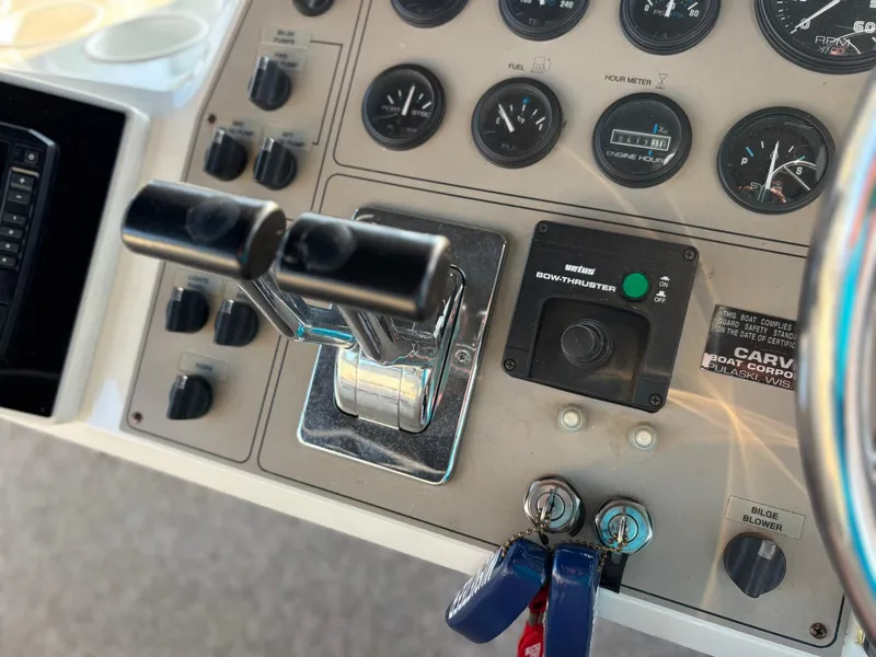 Slide: The Image of Control panel of a 2000 Carver 406 Aft Cabin Motor Yacht with gauges and switches. - 14