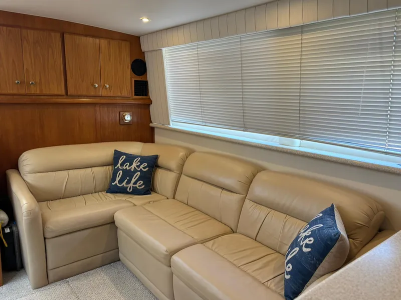 Slide: The Image of Luxurious interior of 2000 Carver 406 Aft Cabin Motor Yacht with beige leather seating. - 19
