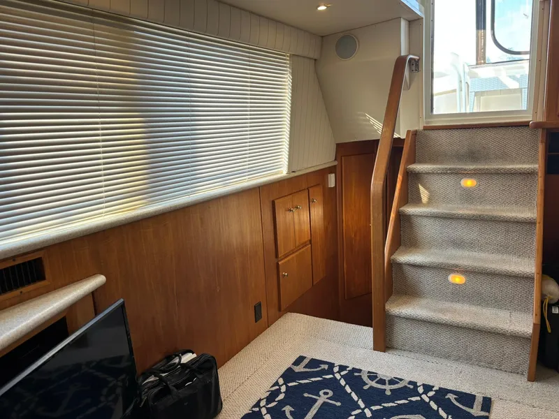 Slide: The Image of Interior of 2000 Carver 406 Aft Cabin Motor Yacht with carpeted stairs and nautical decor. - 20