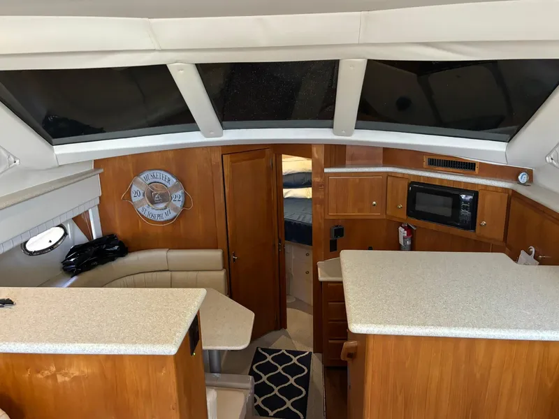 Slide: The Image of Interior of 2000 Carver 406 Aft Cabin Motor Yacht with kitchen and seating area. - 24