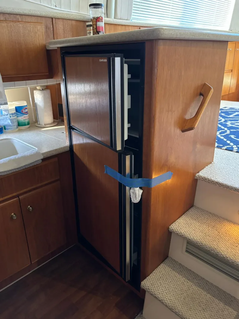Slide: The Image of 2000 Carver 406 Aft Cabin Motor Yacht interior with compact kitchen fridge. - 27