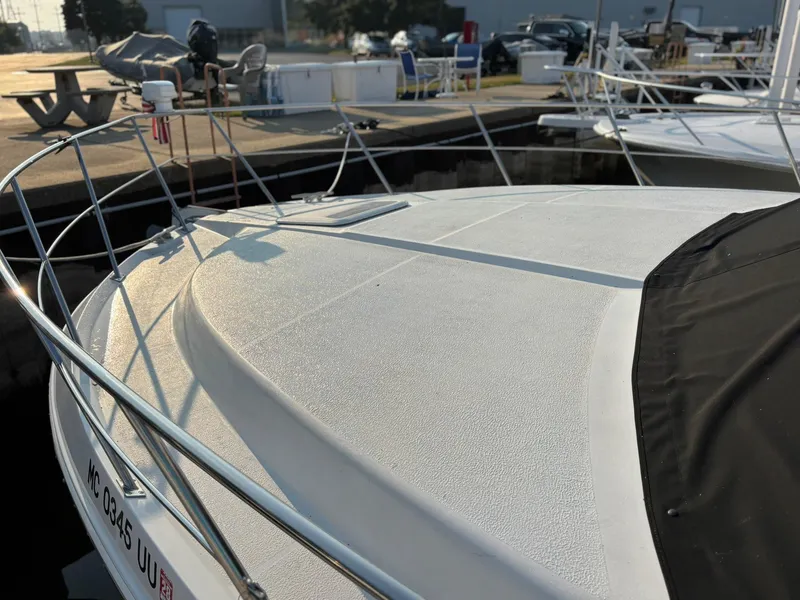 Slide: The Image of 2000 Carver 406 Aft Cabin Motor Yacht docked, showcasing sleek deck design. - 3